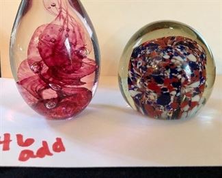 Lot 2446. $48.00. 2 glass paperweights (in next picture) and Jewelry Lot: 4 pins/brooches- "House Pins by Lucinda (ME), Japanese Coat w/hummingbird, Jean Coldwell Arnold watch face, "Wearable Art by Rosemary from Pana, IL". 1 cloisonne belt buckle/tie gatherer, 3 clip earrings, 2 pierced.