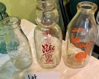 Lot 2464. $65.00. Vintage Bottles (8 pc) and vintage marbles. Lot Includes: Pike Dairy Cream Top with spoon bottle, 2 milk carafes, 1 green glass hinged bottle, 2 ball jars (1 with lid),