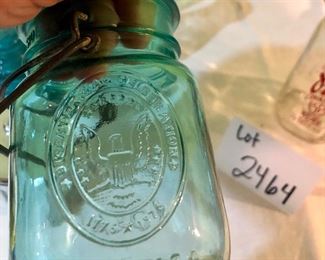 Lot 2464. $65.00. Vintage Bottles (8 pc) and vintage marbles. Lot Includes: Pike Dairy Cream Top with spoon bottle, 2 milk carafes, 1 green glass hinged bottle, 2 ball jars (1 with lid),