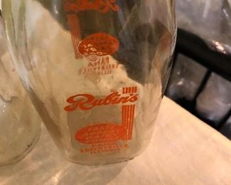 Lot 2464. $65.00. Vintage Bottles (8 pc) and vintage marbles. Lot Includes: Pike Dairy Cream Top with spoon bottle, 2 milk carafes, 1 green glass hinged bottle, 2 ball jars (1 with lid),