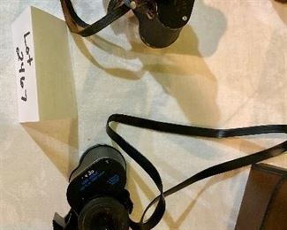 Lot 2467. $60.00. 1 pair of Bushnell Binoculars (Sportview) Insta Focus ST5890 and 1 pair of Binolux Universe No W6-91014 (case is damaged, but has a cool compass on it)