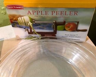 Lot 2472. $40.00. Ready for fall apples and pie making?! Apple Peeler, 3 glass pyrex pie pans (2 different sizes), 1 egg spatula, cow ice cream scoop, and cute clock.