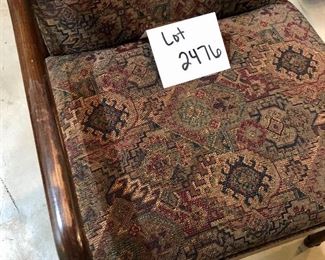 Lot 2476. $75.00. Upholstered Arm Chair with dark stained wood frame. This chair has been loved and it is in great shape. The arms have some wear, but that would be an easy fix! The chair has a southwest feel. 22.5" w x 33"t