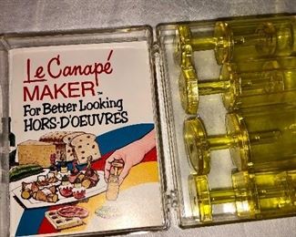 Lot 2482. $28.00. The cutest little set! Enamelware Covered Storage Dish, cute little vintage Le Canape Set (with a book), and 8 sun craft (we are calling them cookie) cutters.