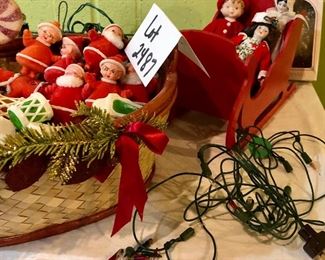 Lot 2487. $160.00. A huge lot of vintage Christmas. Includes a basket filled with vintage flocked Christmas light covers (a Radiant Decorative Light booklet), a Christmas Basket, 2 Gorham Christmas Dolls, one smaller Porcelain doll, 2 vintage stands of lights (1 has a few glass snowflakes).