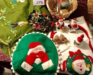 Lot 2496. $40.00. Vintage-Kitsch. Faux floral, 2 wax santas, 2 sequined ornaments, felted skirt, runner and toilet seat cover (hilarious), boxed ornament, gold basket.