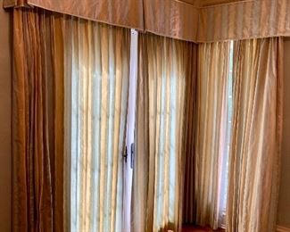 Lot 2443. $550.00. Custom-Made Fine Silk and lined Draperies: Currently covering the openings of 173" of windows (corner is 84"x41", add'l window is 48"wide) color is soft blue and tan with embroidery flower stripes. Includes valance and rings. The fabric alone would cost a fortune. Getting it custom made is sky-high.