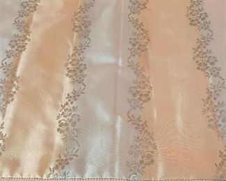 Lot 2443. $550.00. Custom-Made Fine Silk and lined Draperies: Currently covering the openings of 173" of windows (corner is 84"x41", add'l window is 48"wide) color is soft blue and tan with embroidery flower stripes. Includes valance and rings. The fabric alone would cost a fortune. Getting it custom made is sky-high.