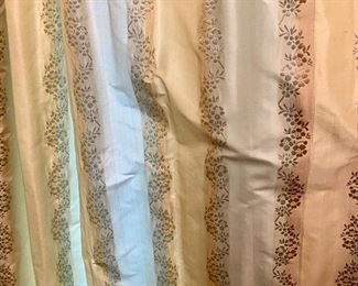 Lot 2443. $550.00. Custom-Made Fine Silk and lined Draperies: Currently covering the openings of 173" of windows (corner is 84"x41", add'l window is 48"wide) color is soft blue and tan with embroidery flower stripes. Includes valance and rings. The fabric alone would cost a fortune. Getting it custom made is sky-high.