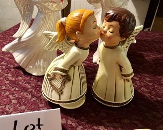 Lot 2529. $38.00. Who doesn't need an angel? This lot includes 6 angels. One is a wood carving wall hanging, pair of white iridescent angels, pair of kissing angels, and a tall slender angel (19").