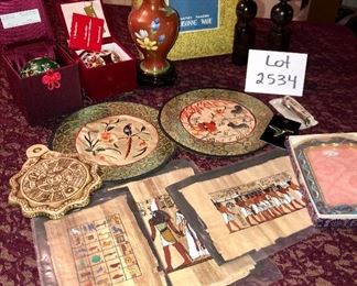 Lot 2534. $60.00. Travel the world in one Lot! Cloisonne vase with stand. 1 cloisonne ornament and 1 green glass ornament, both in their own presentation boxes, an interesting trivet/wall hanging, cloisonne: frame, pin, clippers, candlesticks, circle silks, 3 Egyptian "papyrus" prints. Please note that each one of these items might make a good gift, as nearly all have not been used or displayed and some are in orig. boxes. Do all your Holiday Shopping in one click!