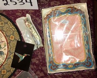 Lot 2534. $60.00. Travel the world in one Lot! Cloisonne vase with stand. 1 cloisonne ornament and 1 green glass ornament, both in their own presentation boxes, an interesting trivet/wall hanging, cloisonne: frame, pin, clippers, candlesticks, circle silks, 3 Egyptian "papyrus" prints. Please note that each one of these items might make a good gift, as nearly all have not been used or displayed and some are in orig. boxes. Do all your Holiday Shopping in one click! Beautiful frame