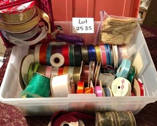 Lot #2535. $28.00. Plastic container full of various ribbons. Great for gift wrapping, crafts, or other projects. Some of these rolls were quite expensive; yours for a fraction of what was originally paid.