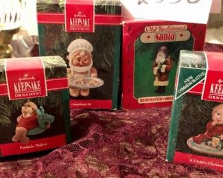 \Lot 2538. $35.00. Mixture of a red and green music box/ornament holders, 4 Hallmark Keepsake ornaments in their boxes, one leaded crystal Hurricane Lamp for a candle in original box, another candle holder, and a basket with 3 cute cheap ornaments in boxes.