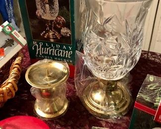 Lot 2538. $35.00. Mixture of a red and green music box/ornament holders, 4 Hallmark Keepsake ornaments in their boxes, one leaded crystal Hurricane Lamp for a candle in original box, another pillar candle holder, and a basket with 3 cute cheap ornaments in boxes.