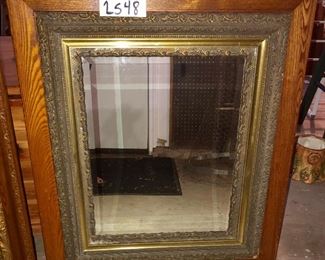 Lot 2548 $125.00 Antique Bevelled Mirror with Oak Frame and Brass Embellishment around Mirror 32" H x 27.5" W.