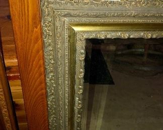 Lot 2548 $125.00 Antique Bevelled Mirror with Oak Frame and Brass Embellishment around Mirror 32" H x 27.5" W.