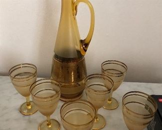 Who doesn't like pretty tinted fancy gold trim decanters and matching goblets