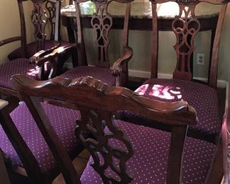 Heckman Dining Table with Two Silver Drawers, Two Extensions (each measures 20" wide), Two Arm/Captain's Chairs, and Six Side Chairs.  Width of the Table is Four Feet, Length of Table without Extensions Six Feet Five Inches, Length of Table with Leaves/Extensions is Ten Feet, Chairs are Upholstered with a Burgundy Fabric with Gold Accent