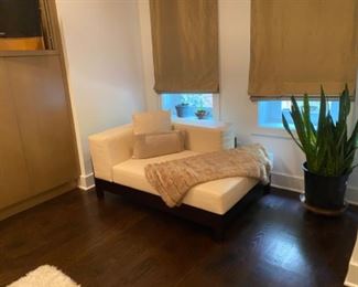 White Sofa, Mini Sectional with Throw Pillows and Blanket. Large Planter and Silk Curtains.