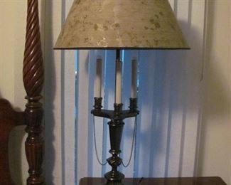 Beautiful Bronzed Three Candle with Two additional Light Bulbs on Top Statement Lamp. Needs new shade as this one has broken arms underneath. We believe this is brass, $45.