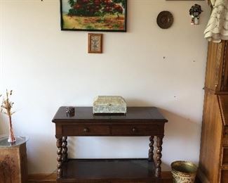 Walnut buffet server with artwork of different periods and countries.