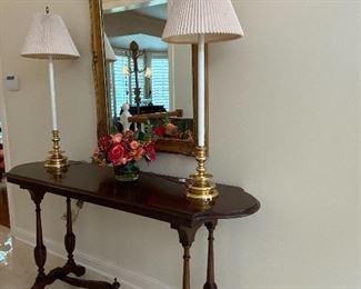 CONSOLE TABLE, ELEGANT MIRRORS AND TALL BRASS BASE LAMPS