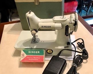 Vintage white Singer Featherweight 221K. The 221K Featherweight is the most wanted sewing machine ever built by the Singer Sewing Machine Company due to its light weight construction, compactness, and high versatility. Relatively few white machines were made, adding to their desirability and collectibility. Produced in 1964 in Kilbowie Scotland.