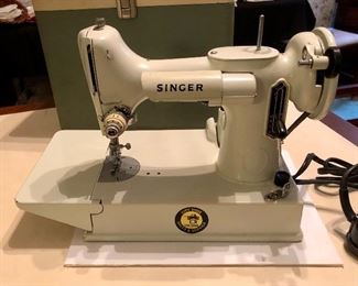 Vintage white Singer Featherweight 221K. The 221K Featherweight is the most wanted sewing machine ever built by the Singer Sewing Machine Company due to its light weight construction, compactness, and high versatility. Relatively few white machines were made, adding to their desirability and collectibility. Produced in 1964 in Kilbowie Scotland.
