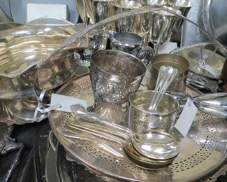 Large table full of silver plate.