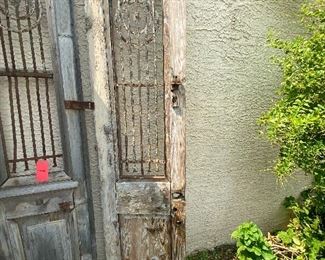 Old rustic wood and iron entry doors yard/garden art sold together 95in tall 22.5in wide each door HxWxD