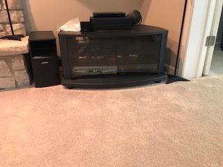 Black stand with shelves and glass doors for electronics     $ 15.00 