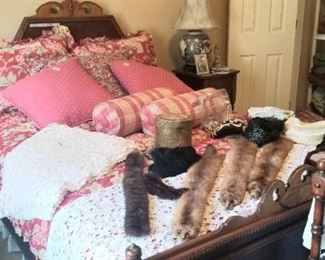 Close up of Victorian bed with plush comforter and pillows