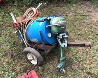 An old Johnson boat motor and a pull behind sprayer.