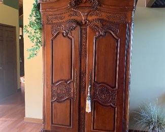 Heavily carved ornate antique armoire, very stately! Quality at its finest!
