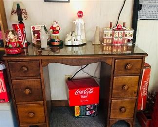 Dove tailed desk with Coca Cola collectibles      1989 transister radio, LED frosted coke, coke music boxes, mr sandman coke, coke christmas village, coke lamp,,,