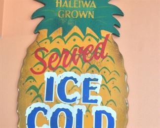 Haleiwa Grown, Served Ice Cold, Pineapple Juice by Steven Neill, 17" x 35". Steven Neill Vintage Hawaiiana Sign Art serves as nostalgic representations of original advertisements and signs that were part of Hawaii's "Golden Days" if the late 1920's and 30's.