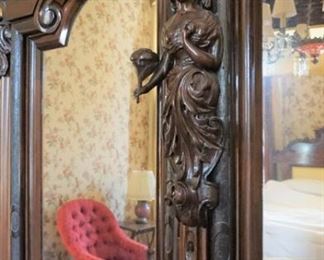 Monumental Heavily Carved Italian Baroque Mahogany Two Door Armoire with lower single drawer.  Solid Carved full body Italian Maiden, Open Pierced Carved Crown and Original Urn Finials. on Carved Feathered Feet  Measures 110" tall, 80" wide & 25" deep.