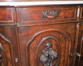 Marble Top Sideboard (Attributed to "Mitchell and Rammelsburg ") with mirrored top and Heavily Carved Fruits, Fish & Foliage.  In Pristine Condition Mahogany  Measures 97" tall, 72" wide and 26" deep 