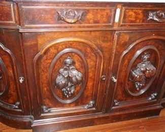 Marble Top Sideboard (Attributed to "Mitchell and Rammelsburg ") with mirrored top and Heavily Carved Fruits, Fish & Foliage.  In Pristine Condition Mahogany  Measures 97" tall, 72" wide and 26" deep 