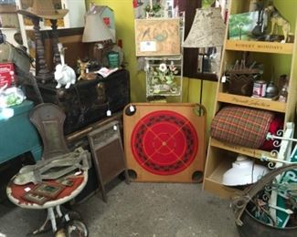 Vintage carrom boards, Girl Scout sleeping bag and old trunks. 