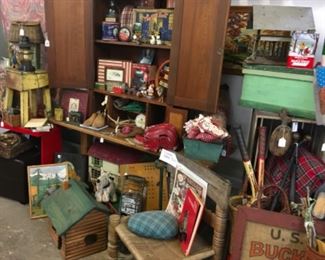 Vintage hutch, mini cabin, pillows and tennis rackets.  