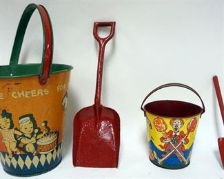 1025	CHILDS TIN SAND BUCKET AND SHOVEL 2 PIECE LOT. 1 MARKED T. COHEN U.S.A., THREE CHEERS FOR THE RED WHITE AND BLUE
