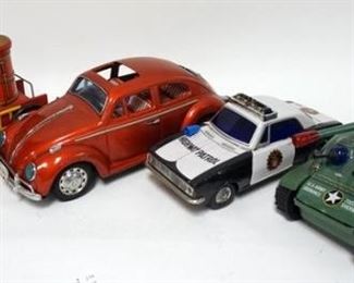 1067	GROUP OF 4 VINTAGE  TIN BATTERY OPERATED TOYS AS FOUND, SOME MISSING PARTS. FIRE ENGINE, POLICE CAR, VOLKSWAGON BUG AND TOY TANK
