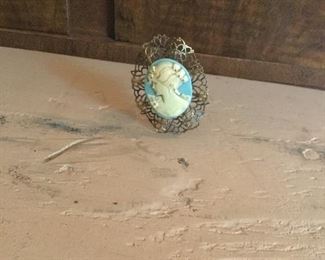 Celluloid cameo with filigree antique hat pin. 