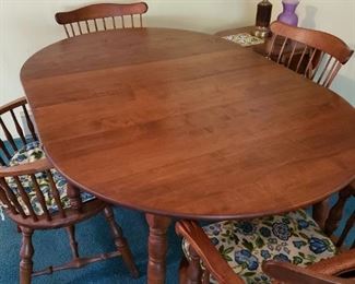 A beautiful Cherry Wood Table and Four Windsor Chairs. The Table and Chairs are in great condition.  2 Leafs. 