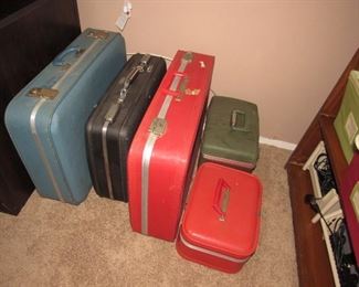 Many pieces of vintage luggage