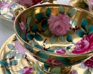 detail - delicate pink roses with green leaves against a gold gilt background