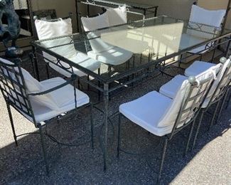 Iron base and glass top rectangular dining table and 8 chairs with cushions plus matching console shown in the back $800