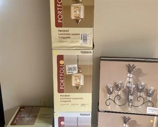new in box light fixtures. 3 matching pendant lights. 2 matching wall sconces, 1 small beaded chandelier